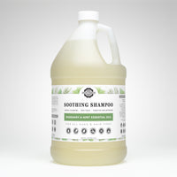 A gallon jug displays Rustic Strength Soothing Shampoo with rosemary and mint essential oils, designed for all ages and hair types.
