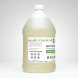 Showcases a gallon-sized bottle of Rustic Strength Soothing Shampoo, highlighting its rosemary and mint essential oil formula for gentle cleansing.
