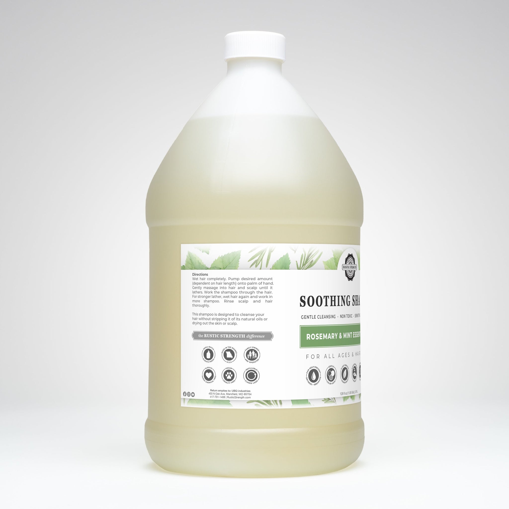 Showcases a gallon-sized bottle of Rustic Strength Soothing Shampoo, highlighting its rosemary and mint essential oil formula for gentle cleansing.
