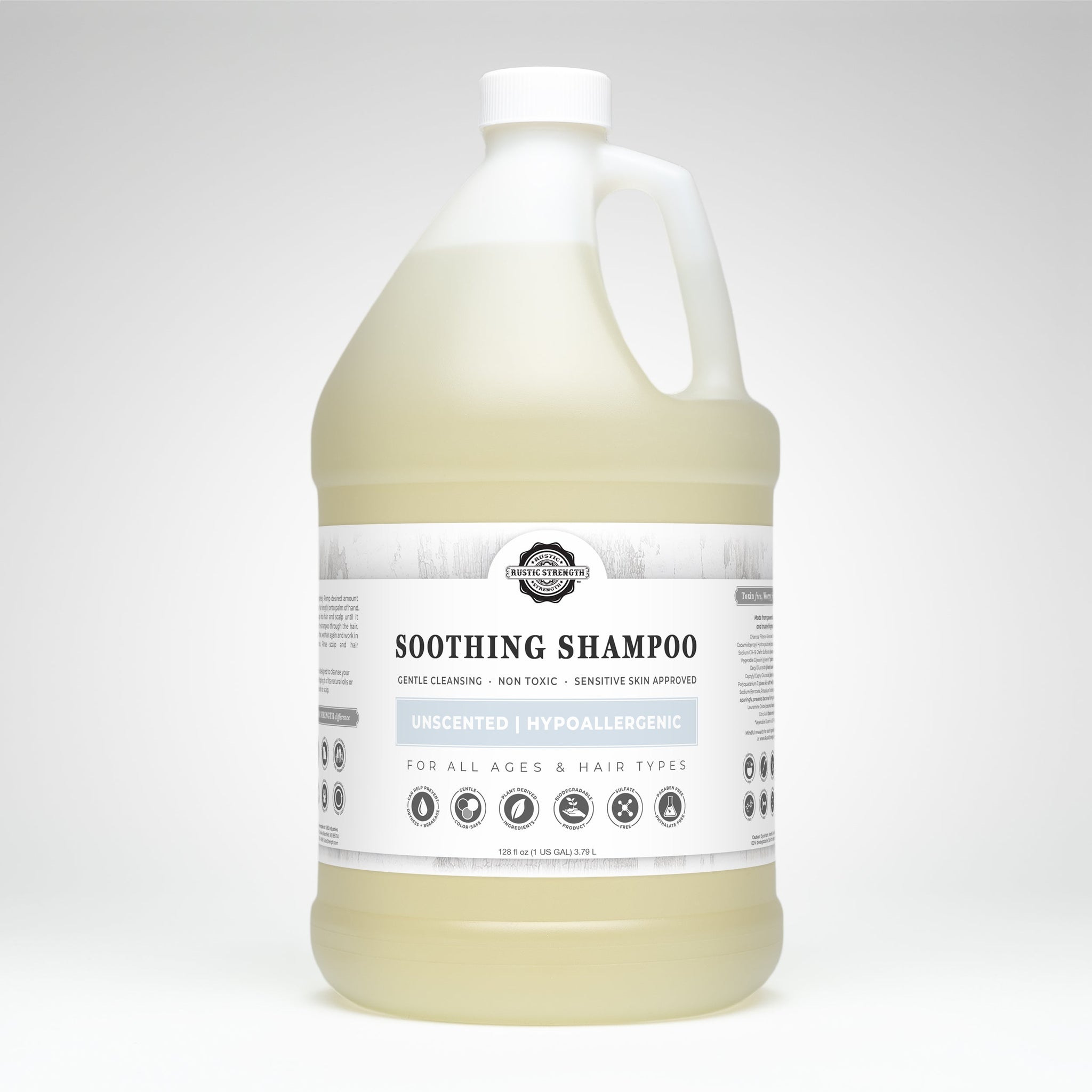 A gallon-sized container presents Rustic Strength Soothing Shampoo, highlighting its gentle cleansing, unscented, hypoallergenic, and sensitive-skin-approved formula for all ages and hair types.
