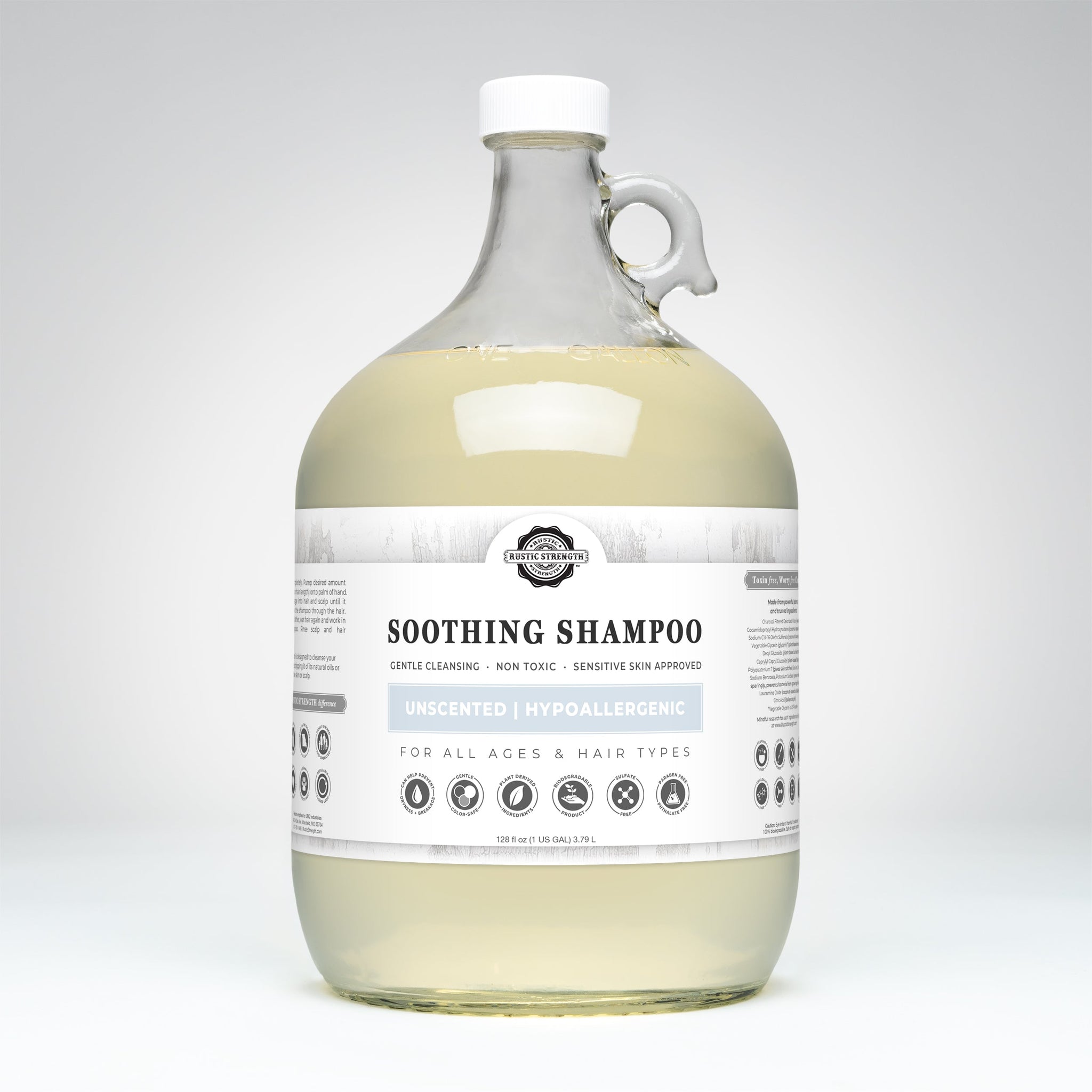 Rustic Strength Soothing Shampoo, a hypoallergenic and unscented haircare product for all ages, sits in a clear glass jug with a white cap.
