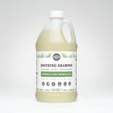 Display shows a bulk-sized bottle of Rustic Strength Soothing Shampoo with rosemary and mint essential oils, formulated for gentle cleansing and suitable for all ages and hair types.