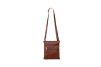 The brown leather crossbody bag features gold zippers and a long adjustable strap, displayed against a clean white background.

