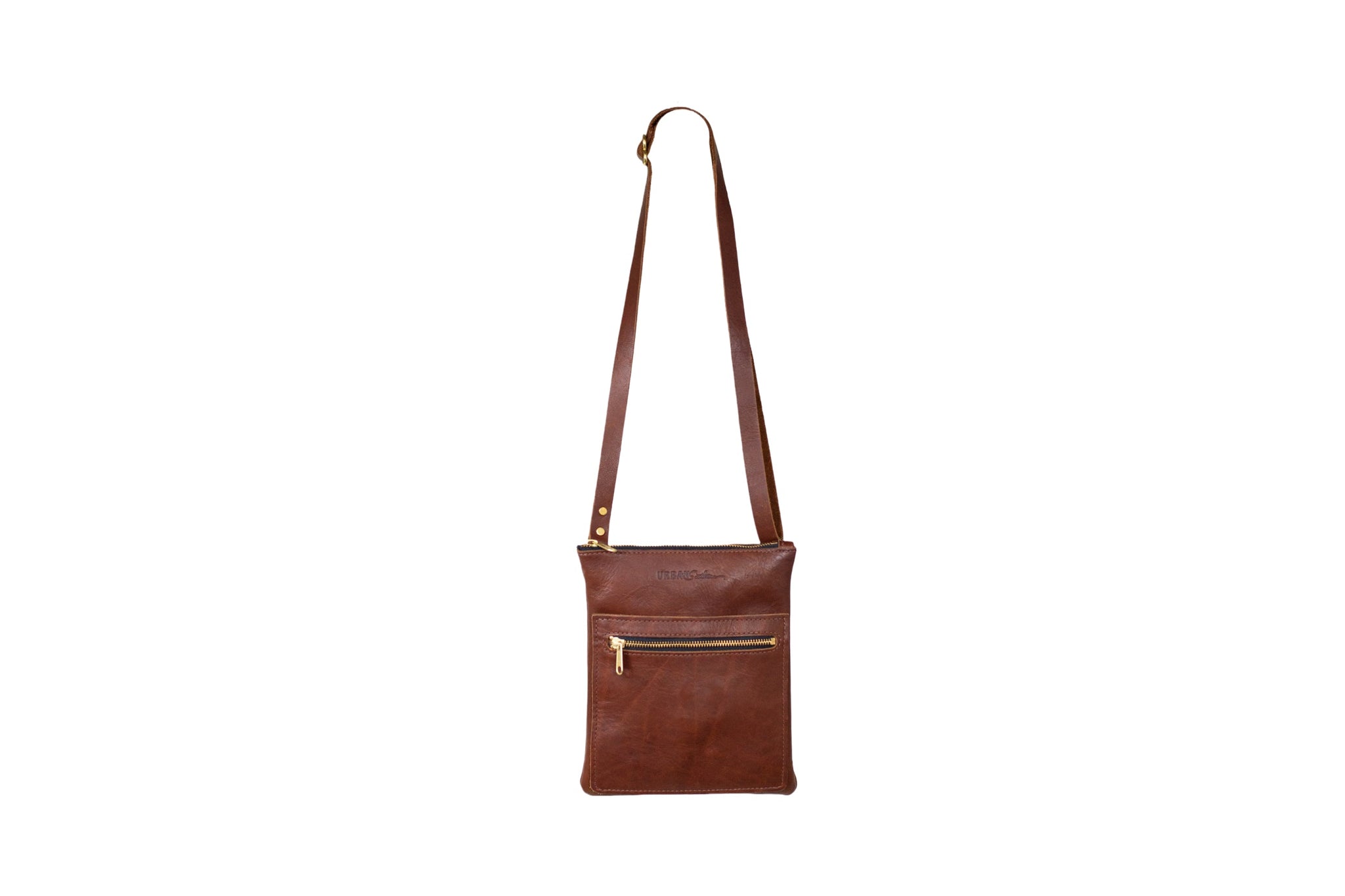 The brown leather crossbody bag features gold zippers and a long adjustable strap, displayed against a clean white background.
