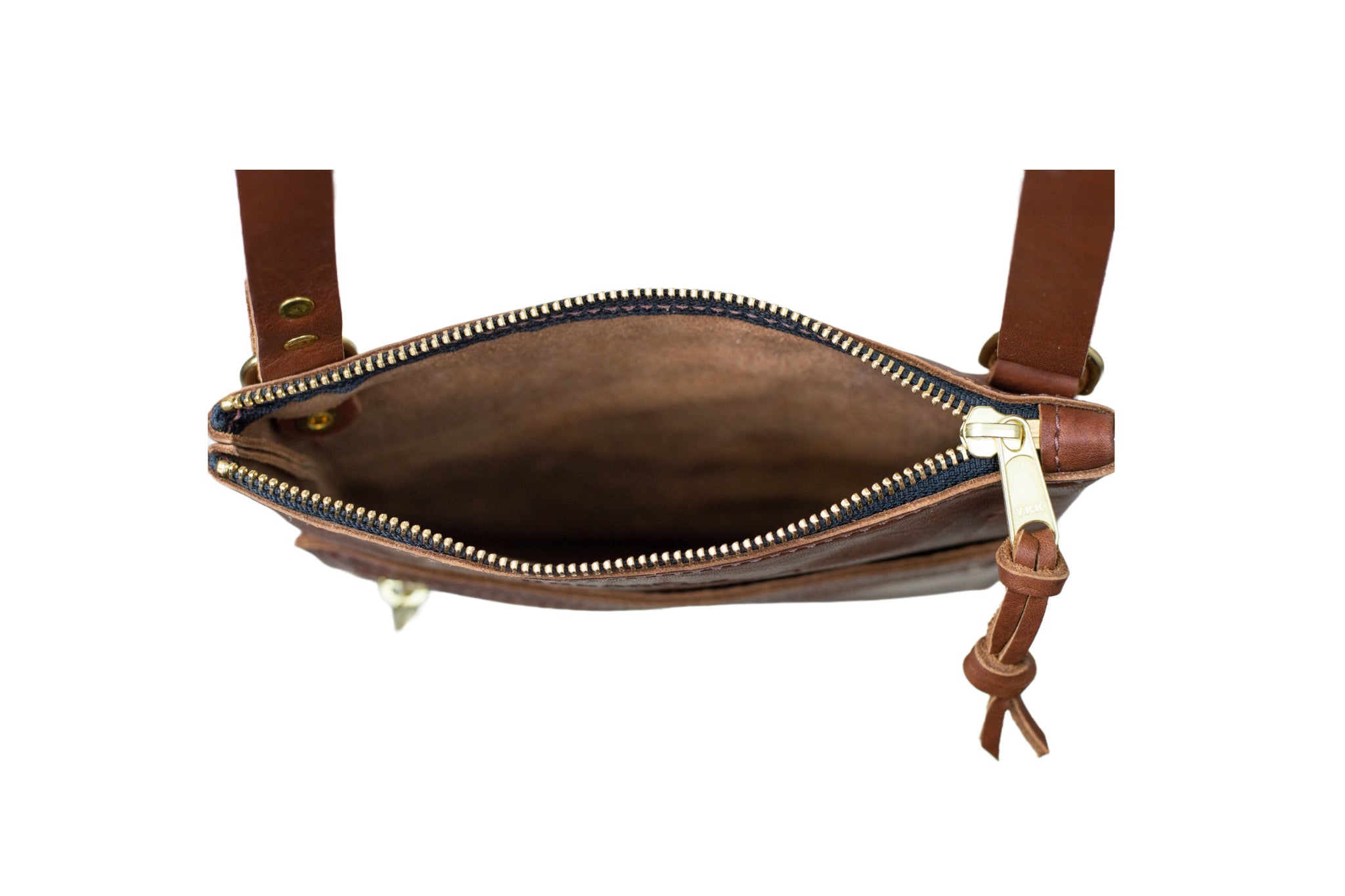 A brown leather crossbody bag shows off its open zipper and spacious interior.

