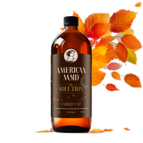 American Maid Ember Vale Solution displays in a glass bottle adorned with autumn leaves.
