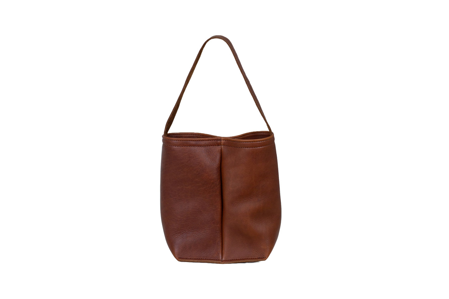 A brown leather bucket bag with a handle sits upright against a white background.

