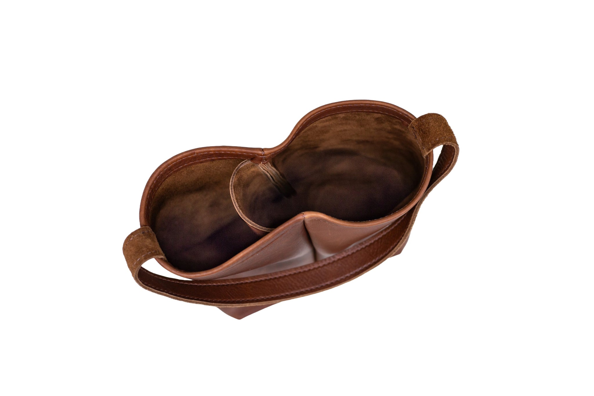 A brown leather tote bag showcases its spacious interior and convenient carrying strap.
