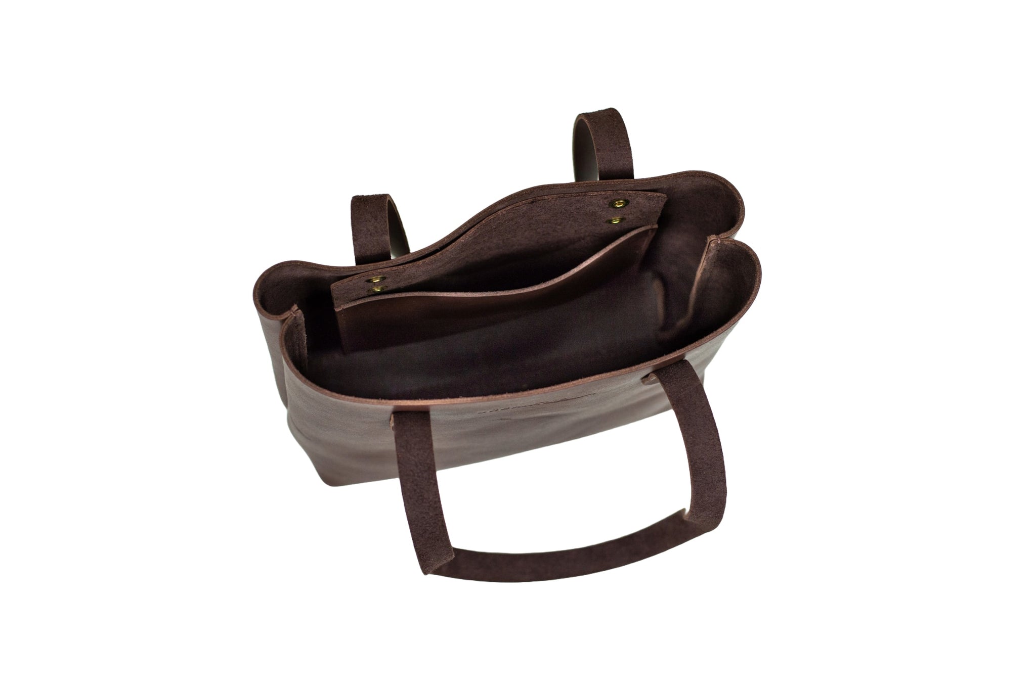 Looking inside, the stylish brown leather tote bag reveals its interior pockets.
