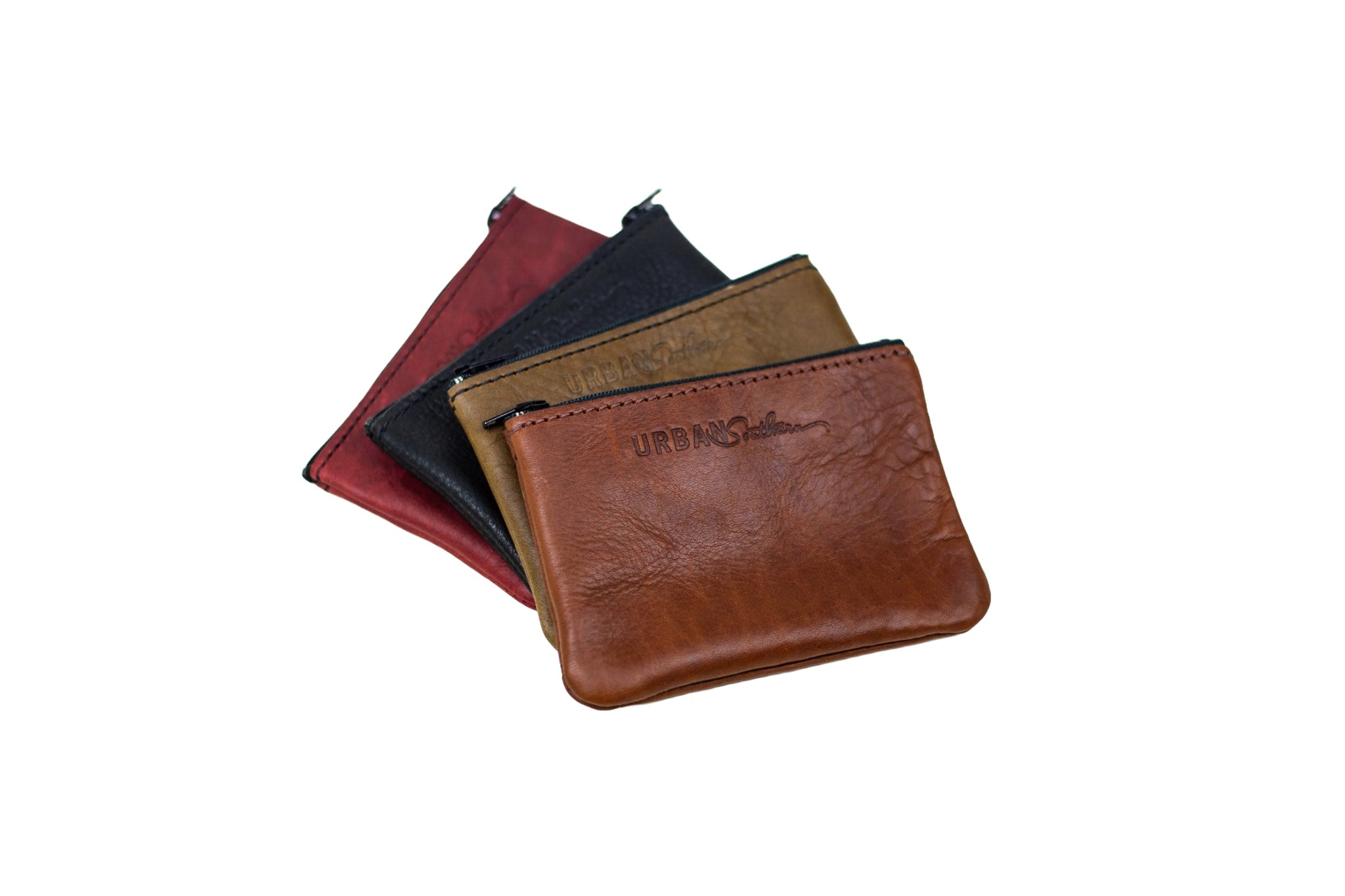 Stack displays four colorful "Urban Southern" leather zippered coin purses against a white background.
