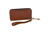 Urban Southern showcases its brown leather zip-around wristlet wallet with a wrist strap on a white background.
