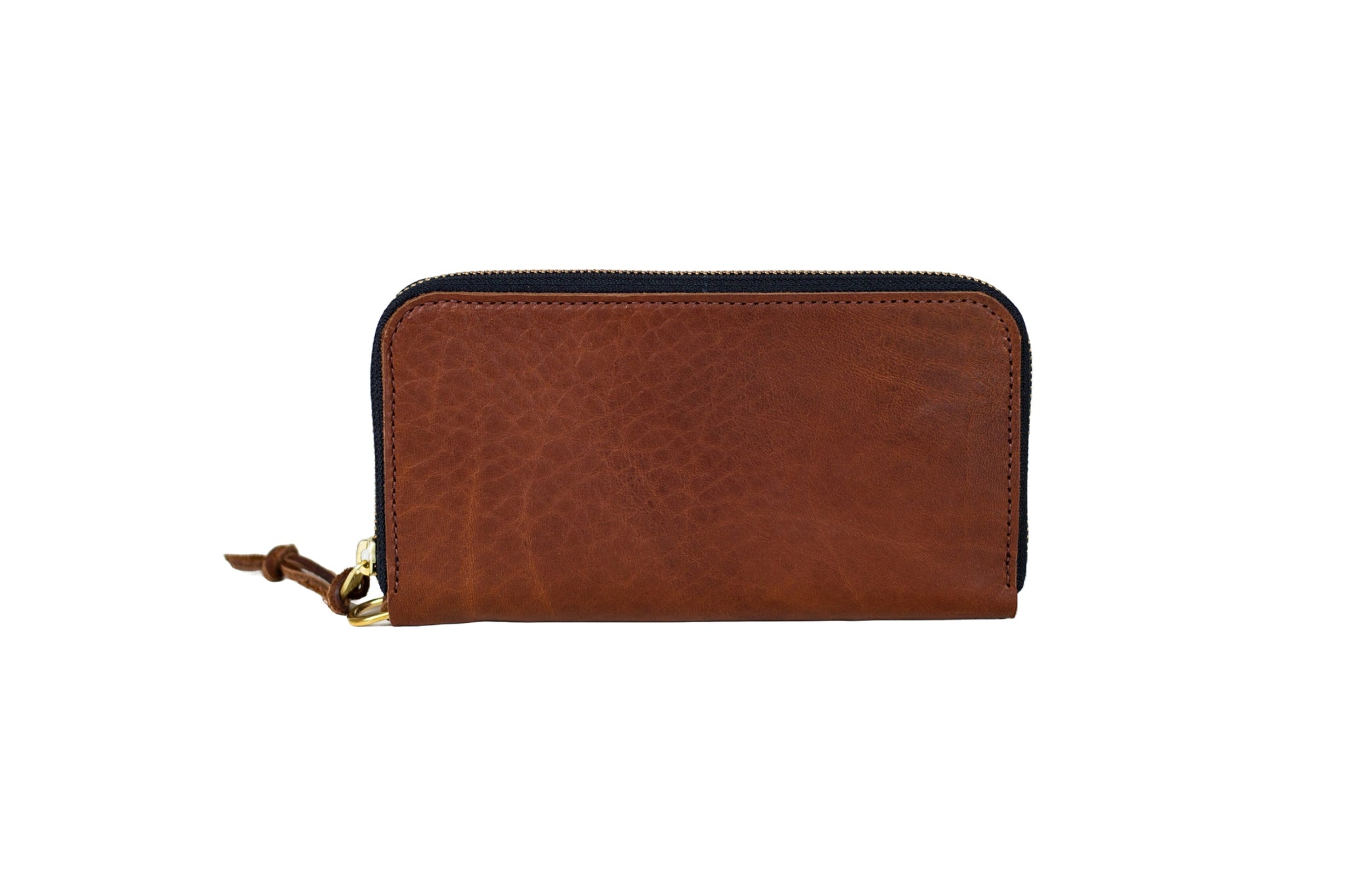 A handcrafted brown leather wallet with a zipper closure sits on a white background.
