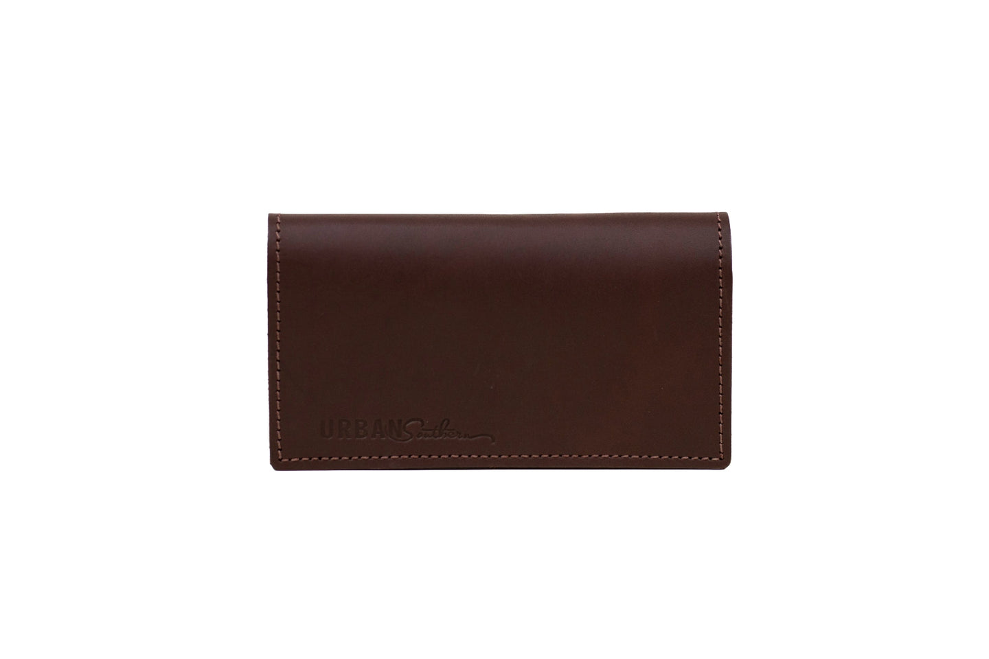 A brown leather business card holder by Urban Southern sits on a white background, showing the stitching detail.
