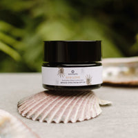 Annmarie Sun Love sunscreen sits on a seashell, advertising everyday sheer broad spectrum SPF 20 protection.
