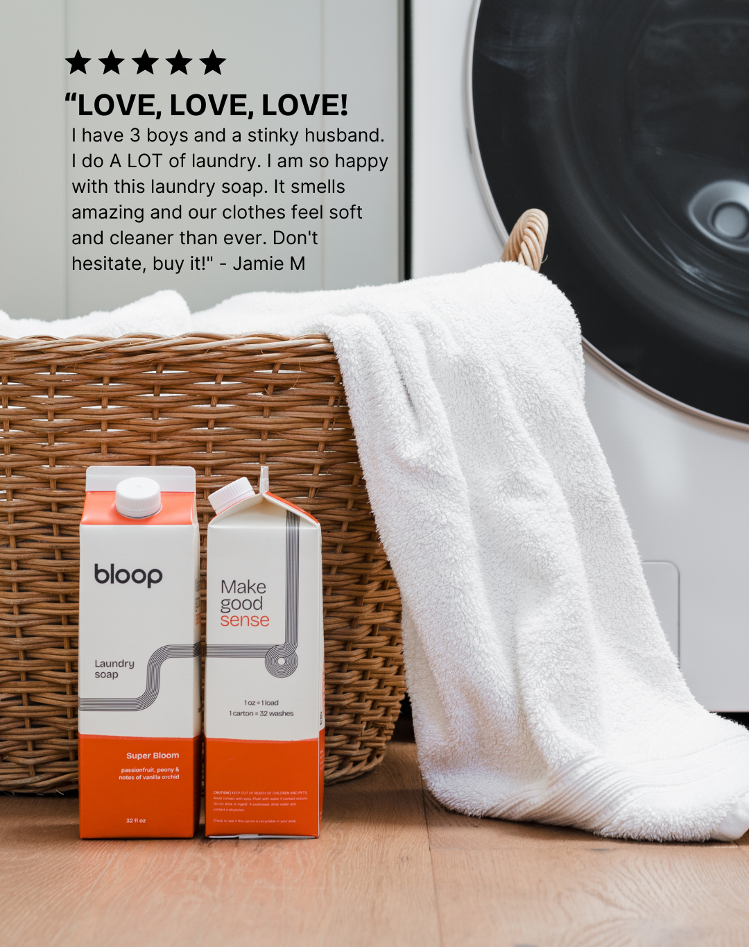 Two cartons of Bloop laundry soap sit beside a wicker basket with a soft white towel, showcasing eco-friendly laundry solutions.

