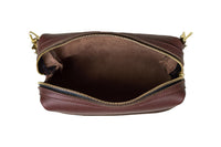 View shows the open brown leather crossbody bag, revealing its interior and gold zipper.
