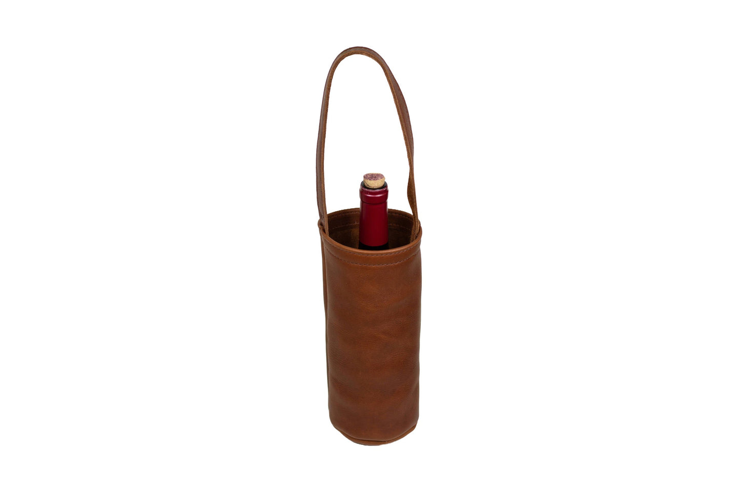 A red wine bottle sits inside a brown leather wine tote with a handle.
