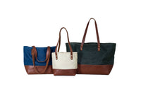 Showcase three stylish Urban Southern tote bags in blue, cream, and green canvas with brown leather accents.
