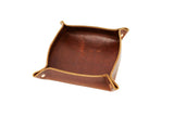 A brown leather valet tray displays the "Urban Southern" leather goods logo.

