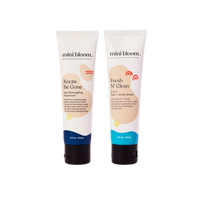 Two tubes of Mini Bloom hair and body products, "Knots Be Gone" detangler and "Fresh N' Clean" 2-in-1 wash, promise gentle, sulfate-free cleansing and detangling.
