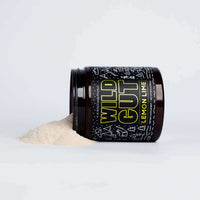 Wild Gut lemon-lime dietary supplement powder spills from its decorative jar onto a white surface.
