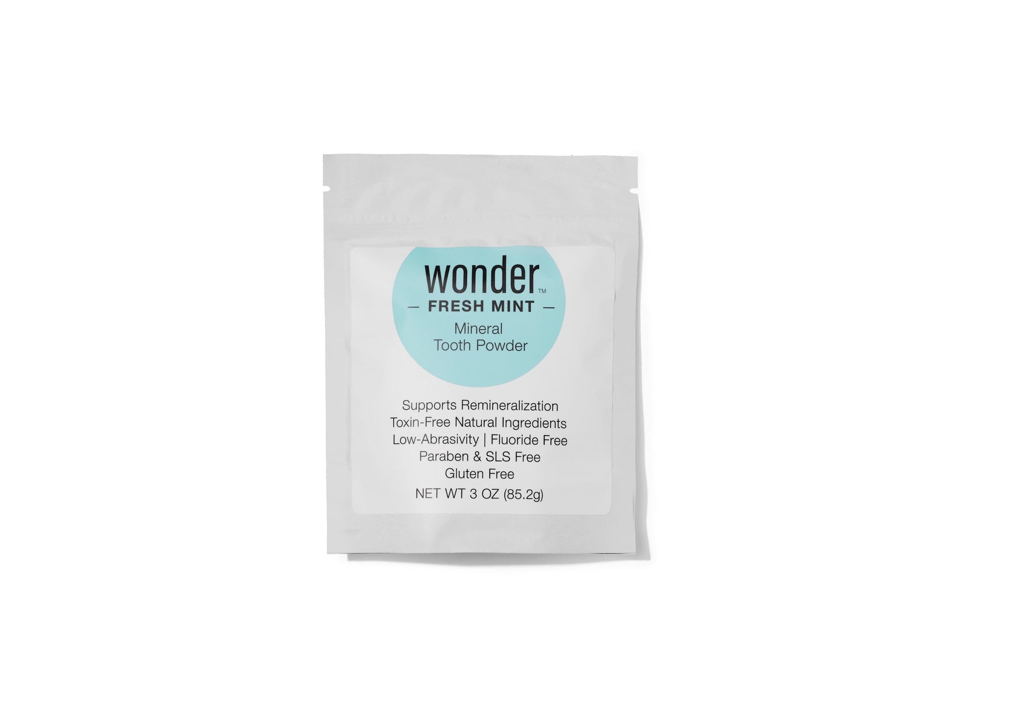 A sealed pouch displays Wonder Fresh Mint Mineral Tooth Powder, highlighting its toxin-free, fluoride-free, and gluten-free formula.
