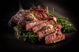 Grilled meat with rosemary on a dark background