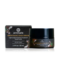 Annmarie Smoothing Hair Serum and its packaging sit on a reflective surface.
