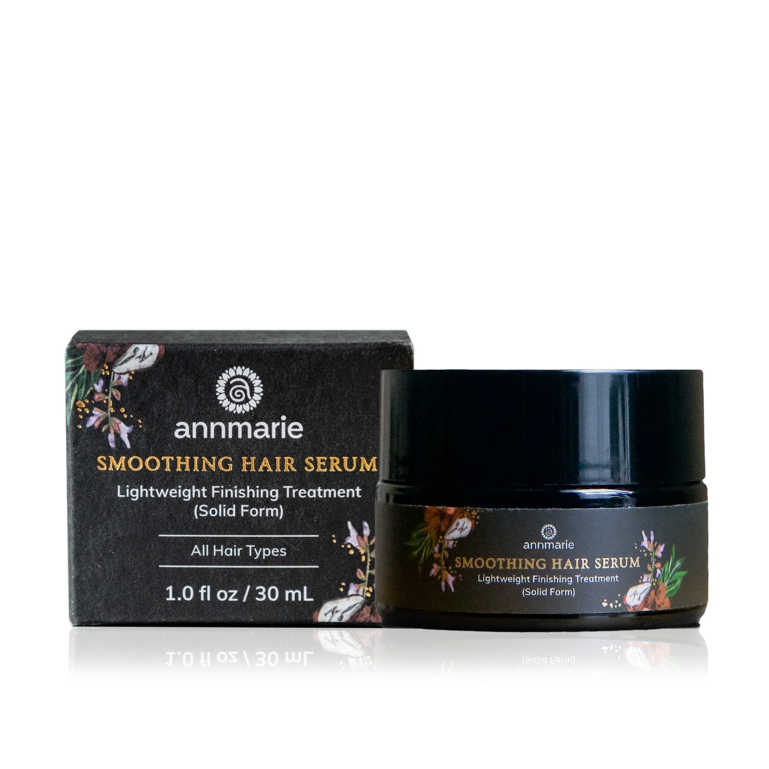 Annmarie Smoothing Hair Serum and its packaging sit on a reflective surface.
