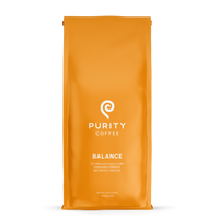 Purity Coffee advertises their "Balance" whole bean organic coffee blend in an orange bag.

