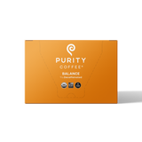Purity Coffee's Balance blend presents its 2/3 decaffeinated USDA organic and bird-friendly naturally water processed coffee in a vibrant orange box.
