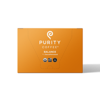 Purity Coffee's Balance blend presents its 2/3 decaffeinated USDA organic and bird-friendly naturally water processed coffee in a vibrant orange box.
