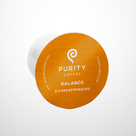 Purity Coffee displays its Balance blend 2/3 decaffeinated recyclable single-serve capsule.
