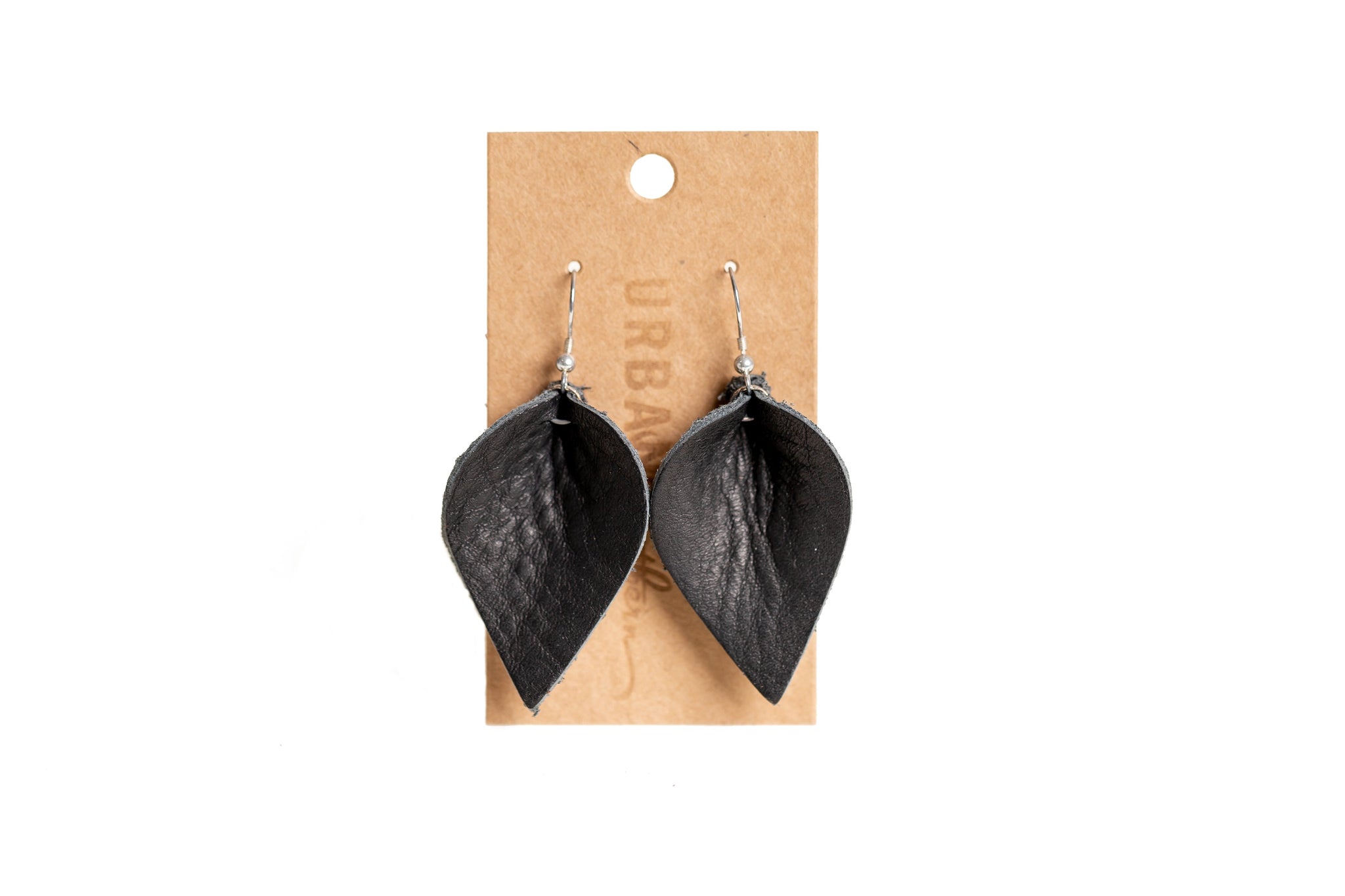 Display shows a pair of stylish black leather leaf earrings on a cardboard display card.
