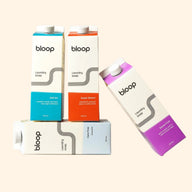Bloop laundry soap offers a variety of scents, including Salt Air, Super Bloom, Care Free, and Stone Fruit, packaged in stylish carton containers.
