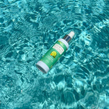 Breathe Naturals cucumber and green tea deodorant spray floats in shimmering turquoise water.
