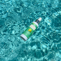 Breathe Naturals cucumber and green tea deodorant spray floats in shimmering turquoise water.
