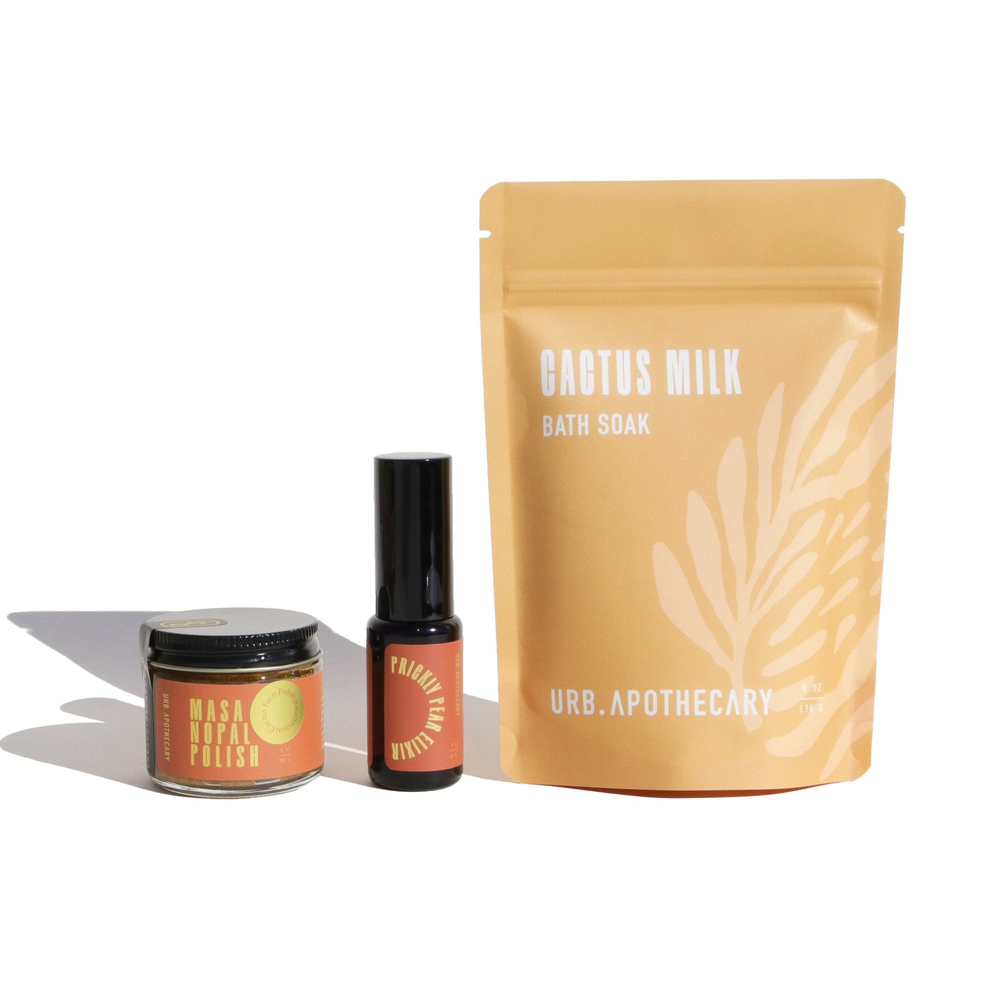 Showcase Urb. Apothecary's Masa Nopal Face Polish, Prickly Pear Elixir, and Cactus Milk Bath Soak against a bright white background.
