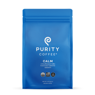 Showcases a blue bag of Purity Coffee Calm, a decaffeinated and consciously crafted ground coffee for serenity.
