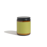 View a santal and fir scented candle in a brown glass jar with a black lid, against a white background.