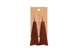 Urban Southern displays brown leather dangle earrings on a kraft paper card.
