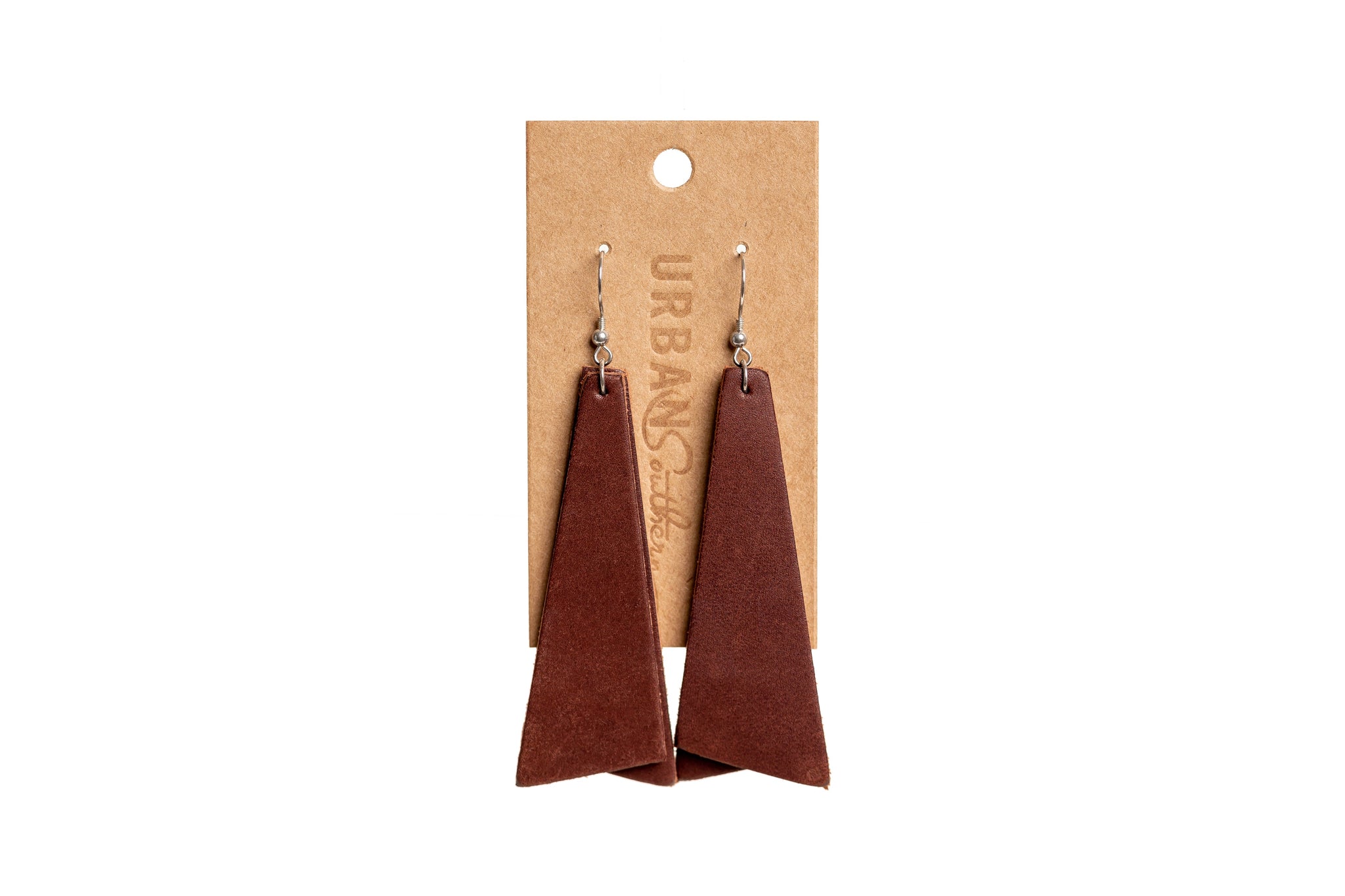 Urban Southern displays brown leather dangle earrings on a kraft paper card.

