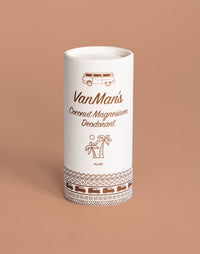 A white tube of VanMan's Coconut Magnesium Vanilla Deodorant displays camper van and palm tree illustrations against a tan background.
