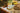 Jar of 'Spring Sunrise' brown butter ghee with bread and bananas on a wooden surface