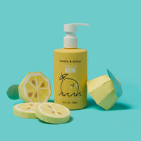 Dabble & Dollop displays its Lemon Gel body wash and shampoo next to papercraft lemon slices.
