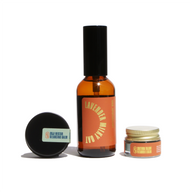 Three Urb Apothecary skincare products, including Lavender Milky Oat spray, Goji Nectar Cleansing Balm, and Solterra Tallow Vitamin C Balm, sit on a white surface.
