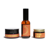 Shows a Goji Nectar Cleansing Balm, Sweetgrass Apothecary Spray, and Solterra Tallow on a white background.