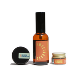 Three Solterra Apothecary skincare products, including Sweetgrass spray, Goji Nectar Cleansing Balm, and Solterra Tallow Vitamin C Balm, sit against a white background.
