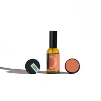 Still life features a bottle of Lavender Milky Oat facial mist and two balm containers from Ure Apothecary skincare products.
