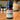 A bottle of Rogue Evergreens Douglas-Fir essential oil sits on a wooden table near a diffuser.
